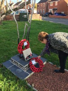 Hazel Brand laying a wreath